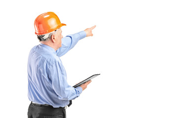 Mature engineer with helmet holding a clipboard and p