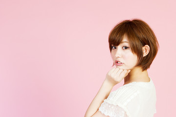 Beautiful young woman on pink background