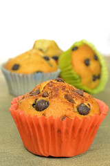 Home made chocolate chip muffins on a wooden board