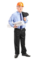 Mature engineer with helmet holding blueprints