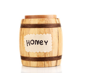 Sweet honey in barrel isolated on white