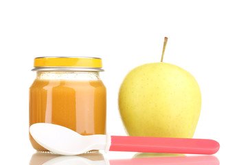 Jar of baby puree with apple and spoon isolated on white