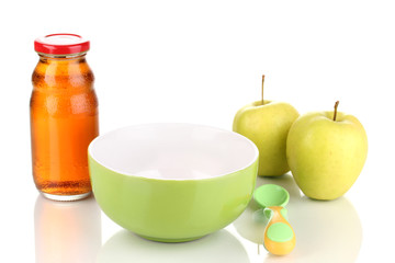 Baby plate and spoon with apple and juice isolated on white