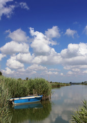 Obraz premium Little blue boat at the lagoon