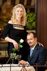 Man and girl with wine at cafe on a date