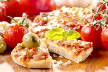 small pizza with olive and tomatoes