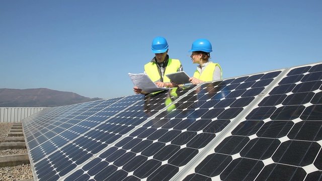 Engineers working on solar panels plant