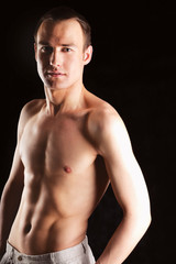 Fototapeta premium Portrait of a naked muscular man ,isolated on black background