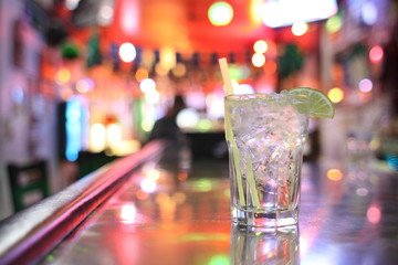 Gin and tonic cocktail at a bar.
