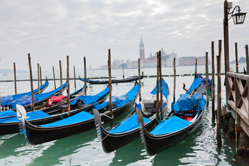Fototapeta na wymiar Gondolas with blue cover in Venice