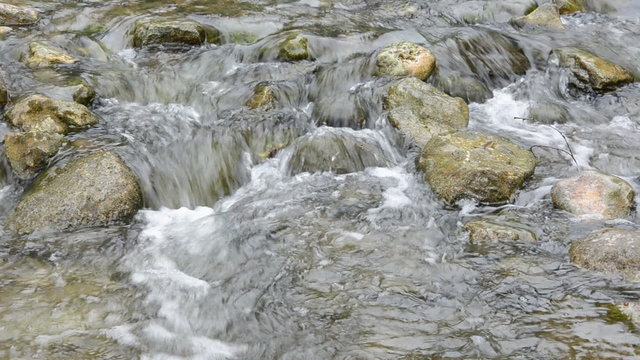 stones in the river and water splash