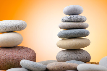 Balanced pebbles with colour background