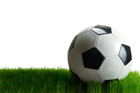 Soccer ball on the grass isolated on white