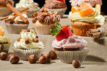 Various muffins with cream, fruits and nuts