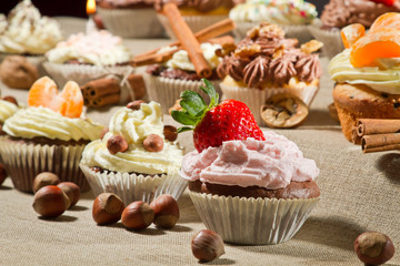 Closeup muffins with cream, fruits and nuts