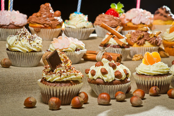 Closeup muffins with cream, chocolate and nuts
