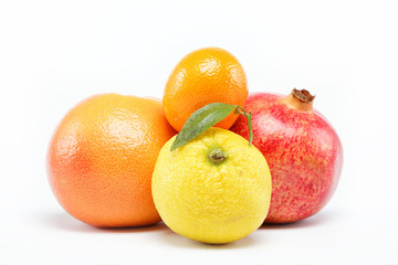pomegranates and citrus fruits isolated on a white background.