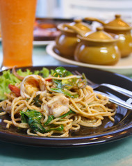 Tasty spice spaghetti with green curry, parsley leaf and seafood