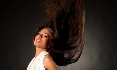 Naklejka premium Beautiful brunette with waving hair