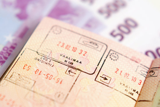 Passport with stamps on a money background