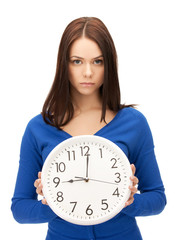 woman holding big clock