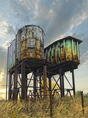 Two rusty industrial barrels