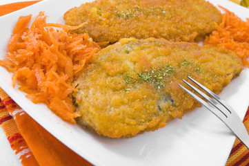Spinach cutlet on white dish.
