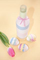 Pink tulips, Easter eggs and yarn wrapped bottle