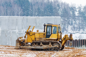 yellow bulldozer working in the winter