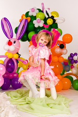Beautiful little girl in balloon forest