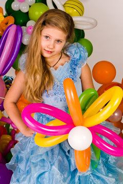 Beautiful little girl in balloon forest