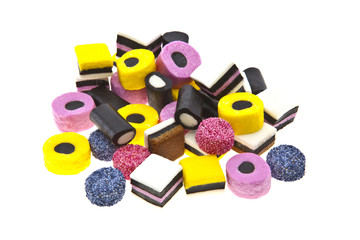 Liquorice allsort sweets in colourful abstract stack design isol