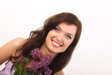 Fototapeta premium Beautiful women with lilac flowers and with purple makeup