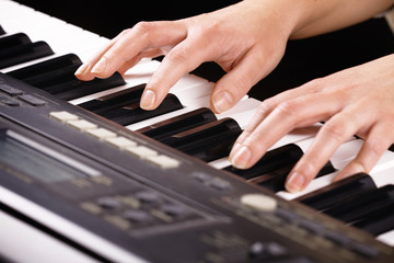 Obraz premium Woman's hands playing music on the piano