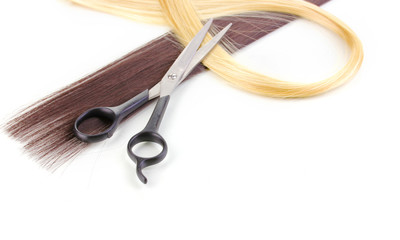 Shiny blond and brown hair with hair cutting shears isolated