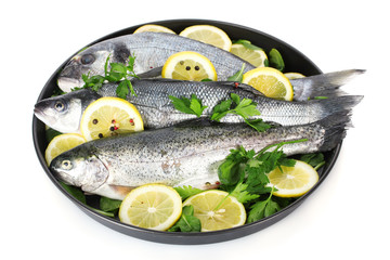 Fresh fishes with lemon, parsley and pepper