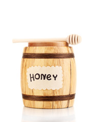 Sweet honey in barrel with drizzler isolated on white
