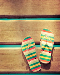 Beach flip flops on wood