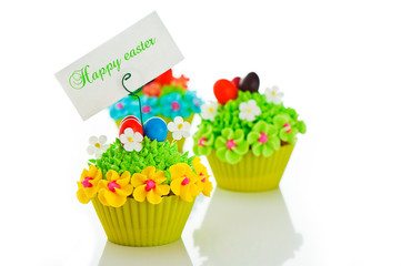 Happy easter cupcake with chocolate egg and cream grass as a mea