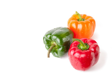 Three bell peppers of different color, isolated over white