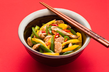 Fried Chicken with capsicum on red table cloth