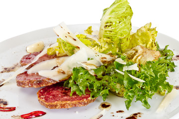 Salad from fried sausages, lettuce with sour cream sauce