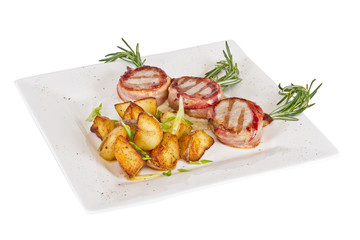 Grilled steak wrapped in bacon, with grilled vegetables