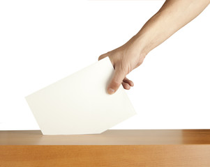 Hand putting a voting ballot in a slot of box isolated