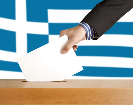Hand with ballot and box on Flag of Greece