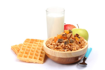 tasty cornflakes in wooden bowl, apples and glass of milk