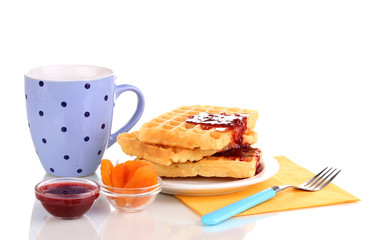 Tasty waffles with jam on plate isolated on white
