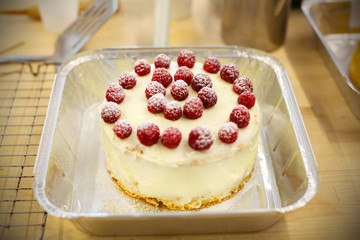 Victoria sponge cake iced with mascarpone cheese and raspberries