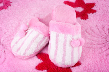 pink home slippers on fluffy bath rug