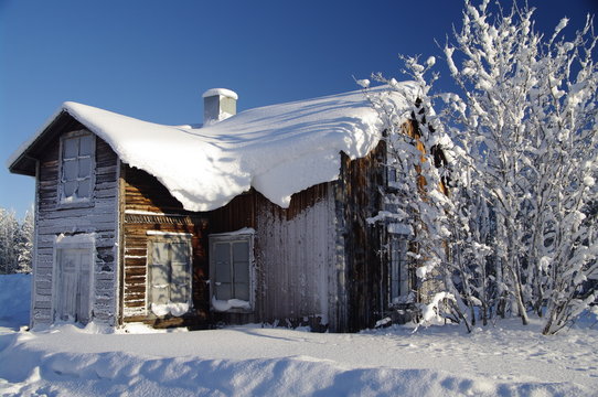Fototapeta Swedish house at a sunny winter day
